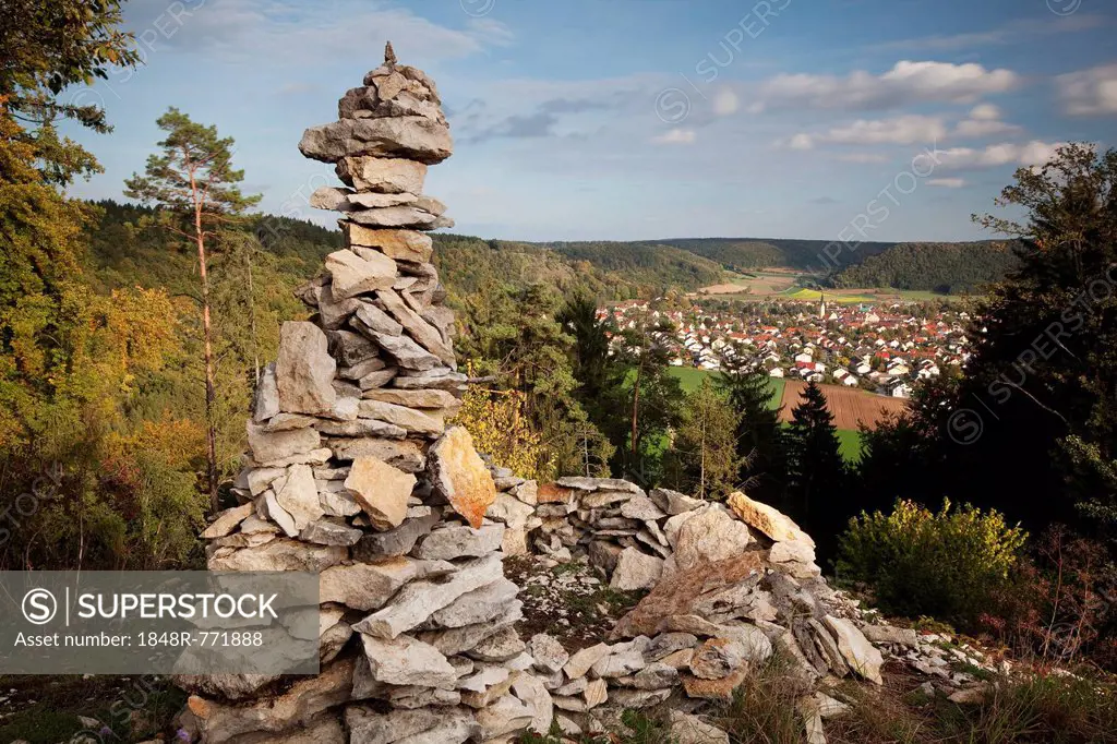 View past a cairn towards Dietfurt from Hirschblick lookout, Dietfurt, Bavaria, Germany