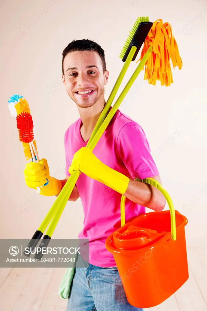 Man holding cleaning products in his hands, Mannheim, Baden-Württemberg, Germany
