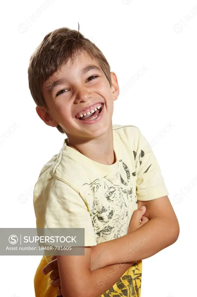 Boy, 6, laughing with his arms crossed, Germany