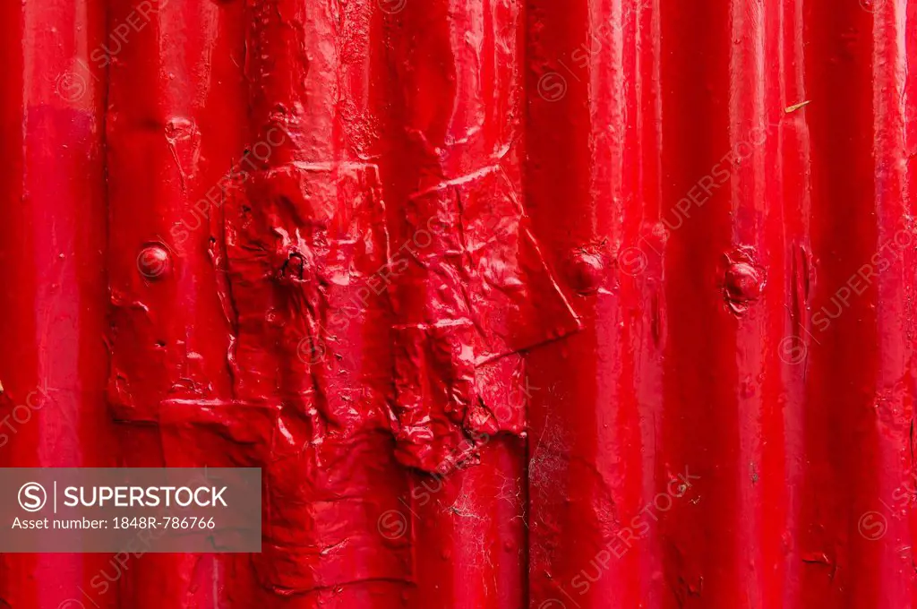 Corrugated iron, painted red, partially repaired