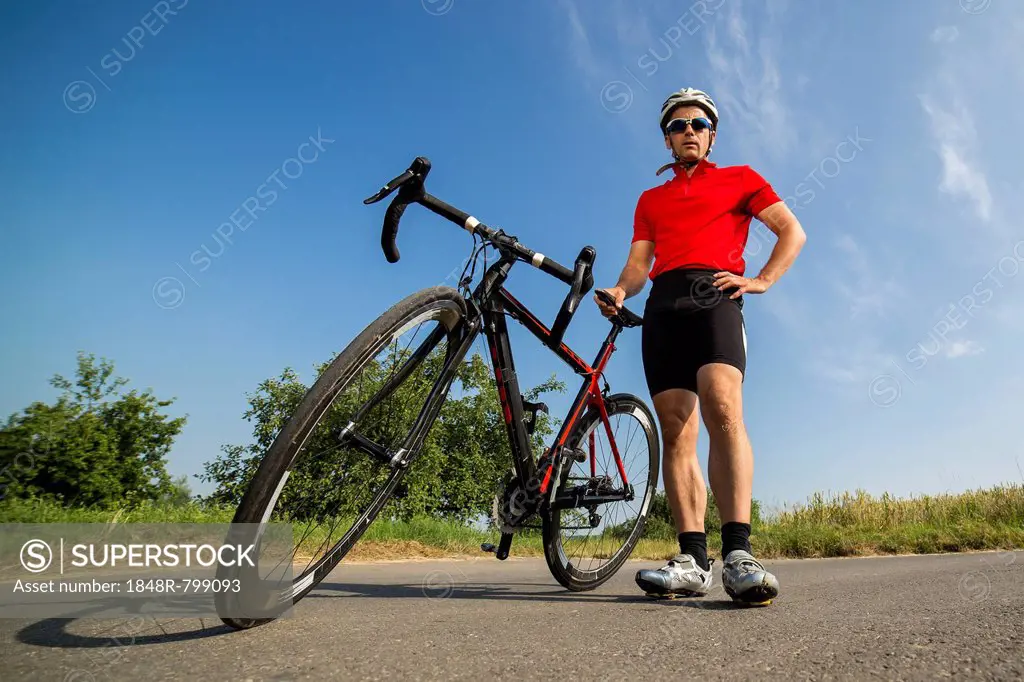 Cyclist, 44 years, standing next to a racing cycle, Winterbach, Baden-Württemberg, Germany