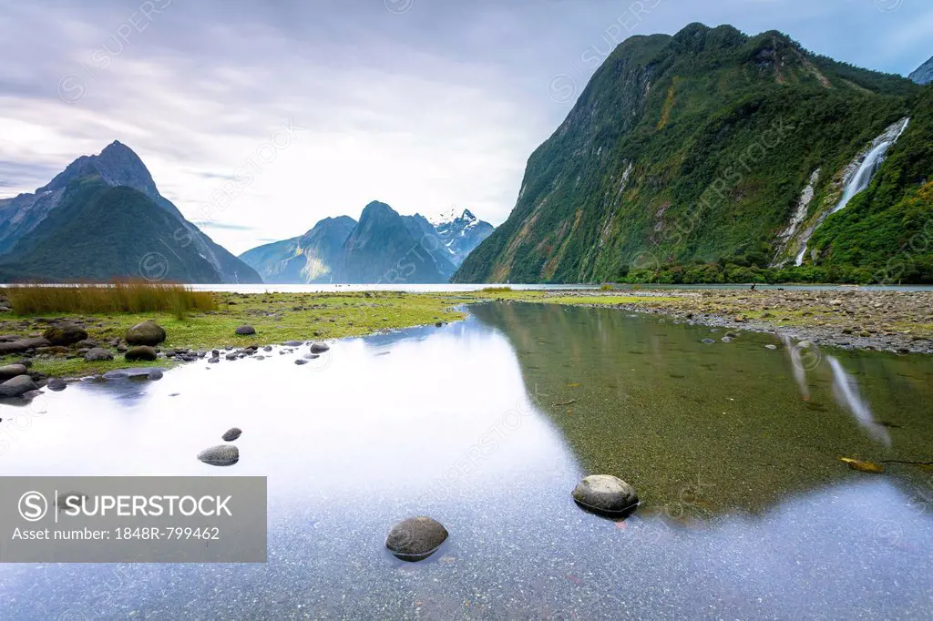 Evening at Milford Sound with Mitre Peak, 1683m, Cascade Peak, 1209m, and the Bowen Falls, 162m, Fiordland National Park, Southland Region, New Zealan...