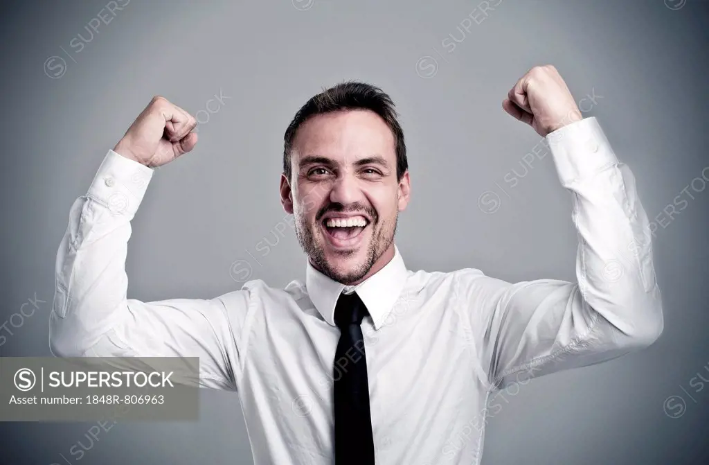 Young man wearing a shirt and a tie cheering, laughing, success, victory pose