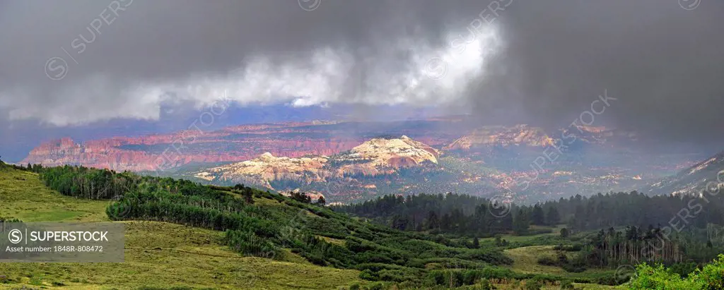 View through the clouds from the green forested Boulder Mountain towards Capitol Reef, Boulder Town, Utah, United States