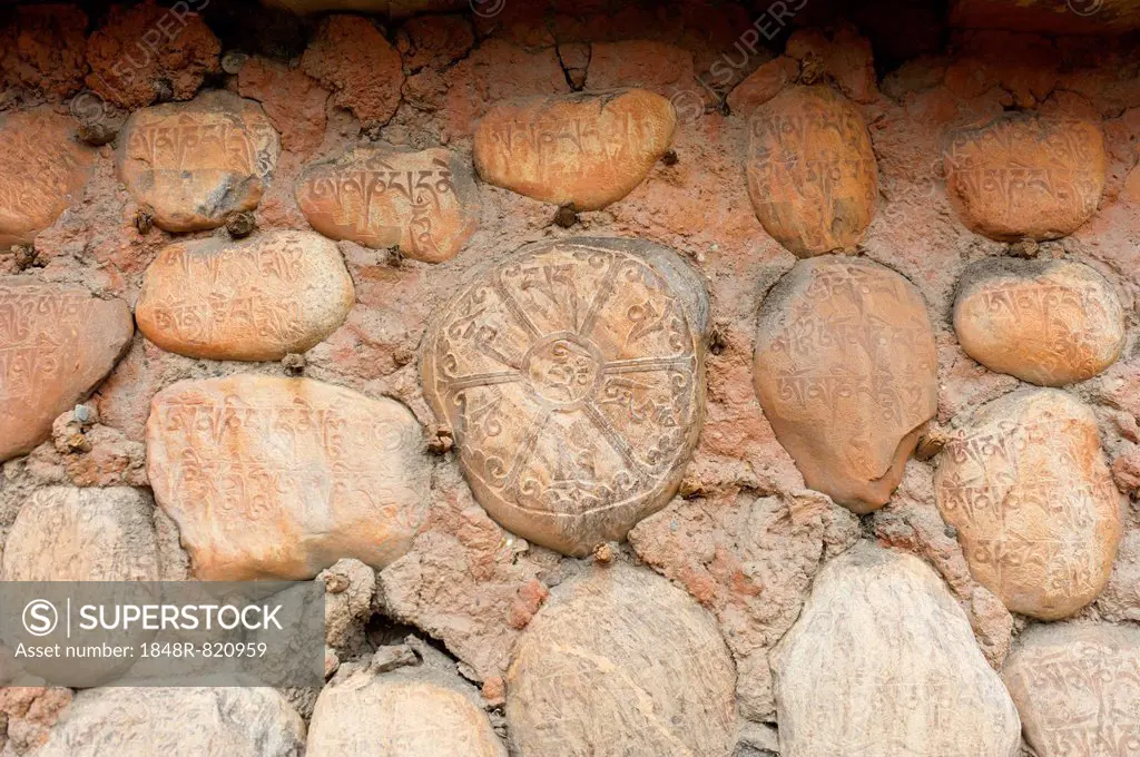 Mani stones with Tibetan inscriptions on wall, Buddhist Mani wall at Ghami, Upper Mustang, Nepal, Asia