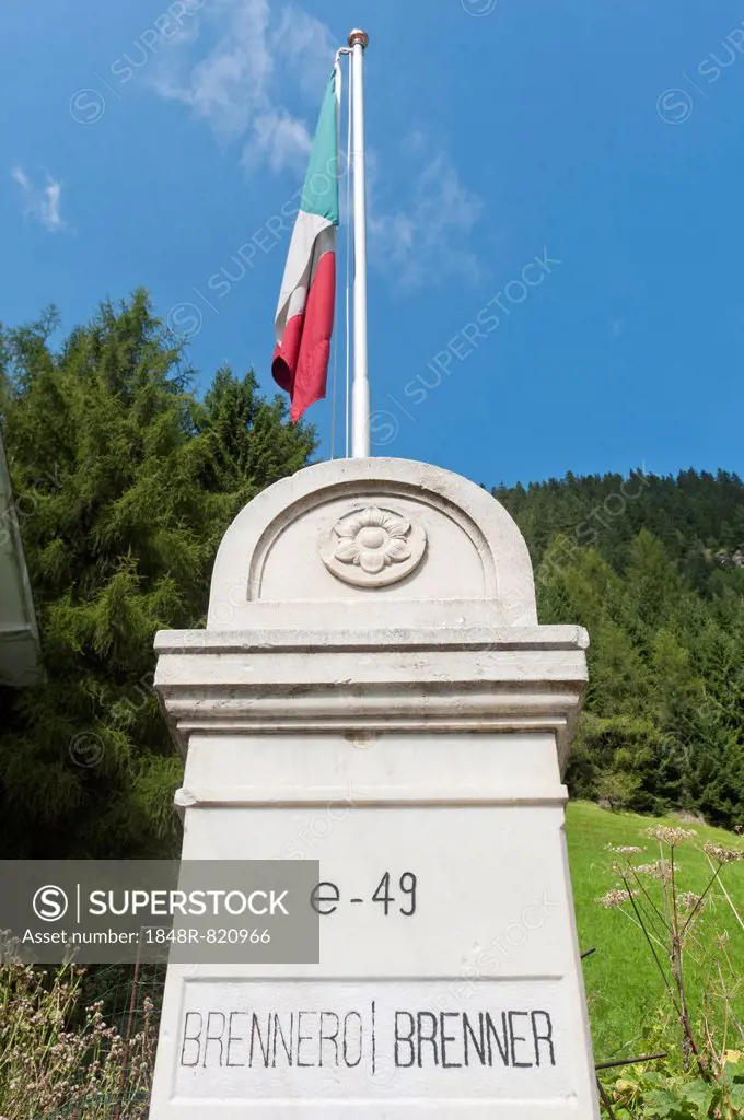 State border at the Brenner Pass, old boundary stone between Italy and Austria with the Italian national flag, Brenner, South Tyrol province, Trentino...