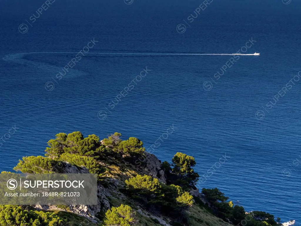 Coastline, motorboat at back, Cap Formentor, Majorca, Balearic Islands, Spain