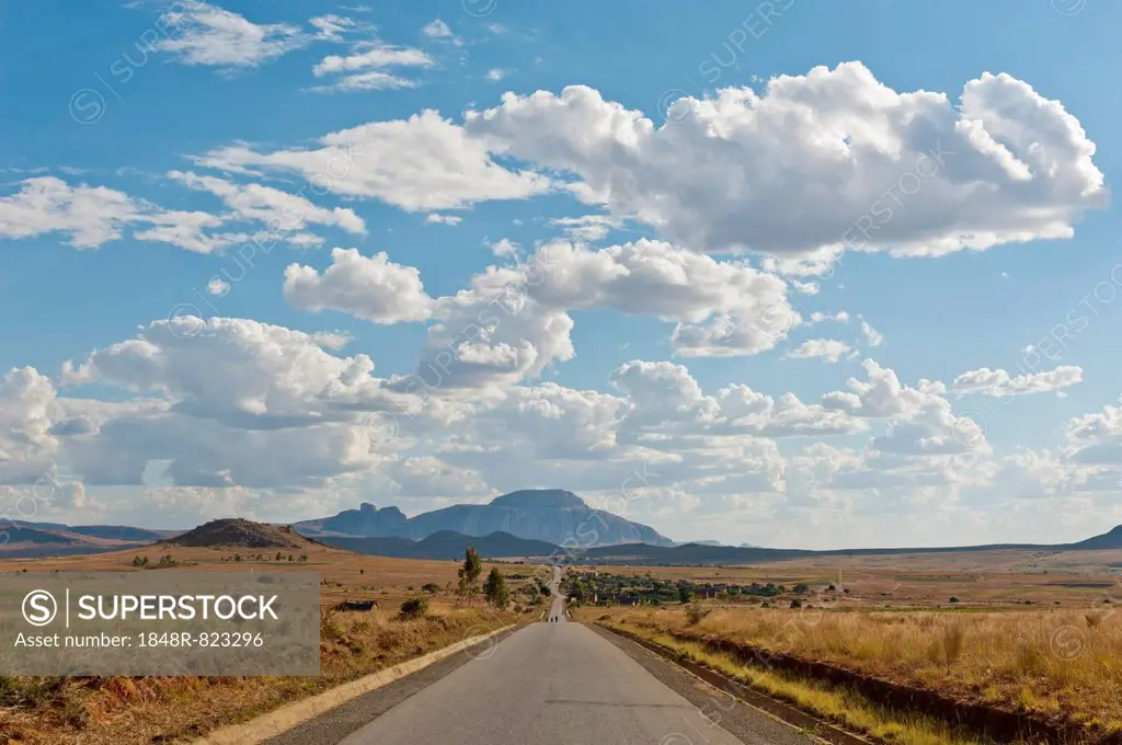 Long straight road, vast arid landscape, sky with clouds, Isalo National Park near Ranohira, Madagascar
