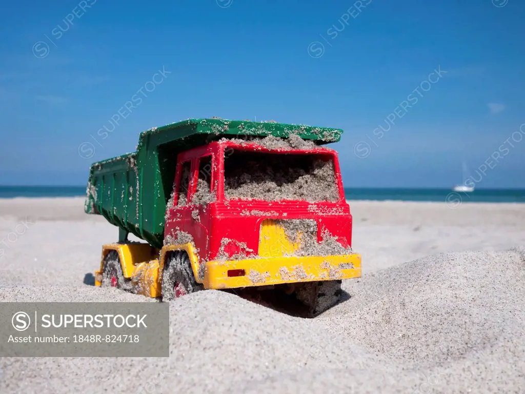 Toy dumper truck on a beach, Mecklenburg-Western Pomerania, Germany