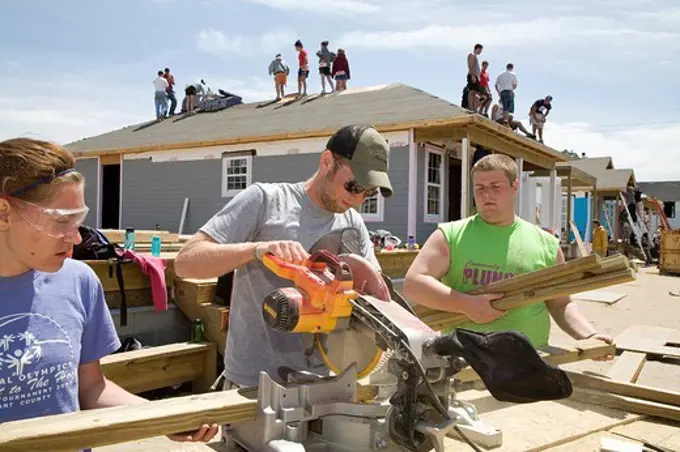 Young volunteers build new houses in a Habitat for a Humanity project to replace some of the housing destroyed by Hurricane Katrina, New Orleans, Louisiana, USA