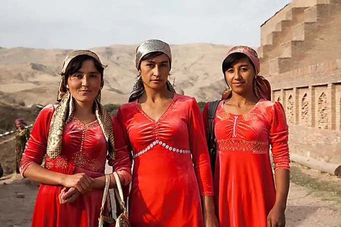 Women with red dresses, Uzbekistan, Asia