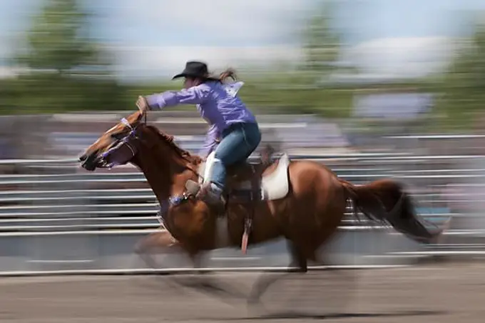 First Nations woman, motion blur, barrel racing, T'suu Tina rodeo, Bragg Creek, Alberta, Canada, North America