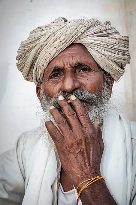 Elderly Indian man resting on a bed, Jaisalmer, Rajasthan, India, Asia