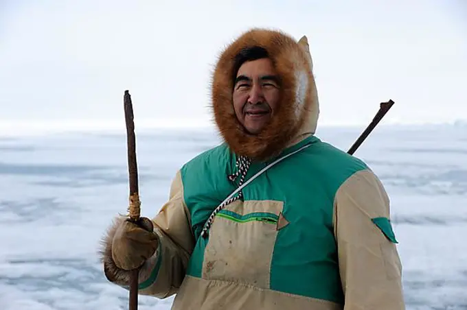 Portrait of Inuit hunter on icepack, Floe Edge, Arctic bay, Baffin Island, Nunavut, Canada, North America