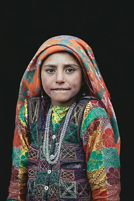 Malia, a Wakhi girl in traditional traditional traditional traditional traditional traditional traditional traditional traditional traditional costume at the door of her family's house, Saradh-e-Broghil, Afghanistan, Asia