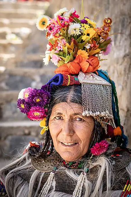 Ladakh, India, August 29, 2018: Portrait of an indigenous elderly woman with traditional flower hat in Ladakh, India. Illustrative editorial, Asia