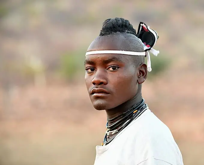 Young Himba man with traditional hairstyle, Portrait, Kaokoveld, Namibia, Africa