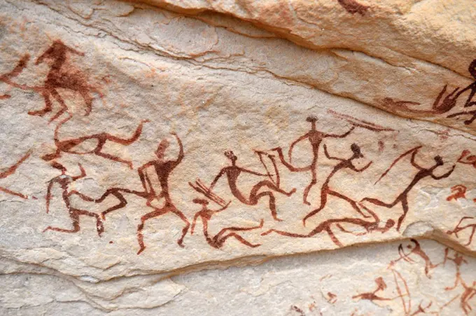 Group of painted warriors or hunters, neolithic rockart at Arakokem, Adrar Tekemberet, Immidir, Algeria, Sahara, North Africa