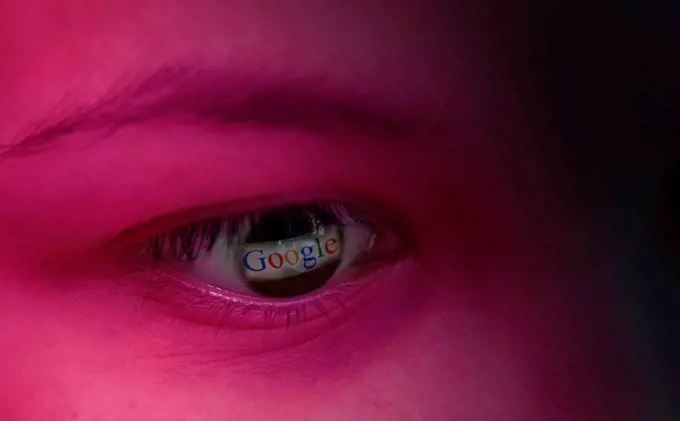 The Google logo is reflected in an eye, symbolic image