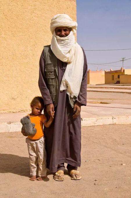 Toddler standing next to his father, Tadrat, Tasset, Algeria, Africa