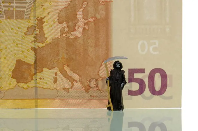Death standing in front of a 50 euro note, symbolic image for the crisis of the euro