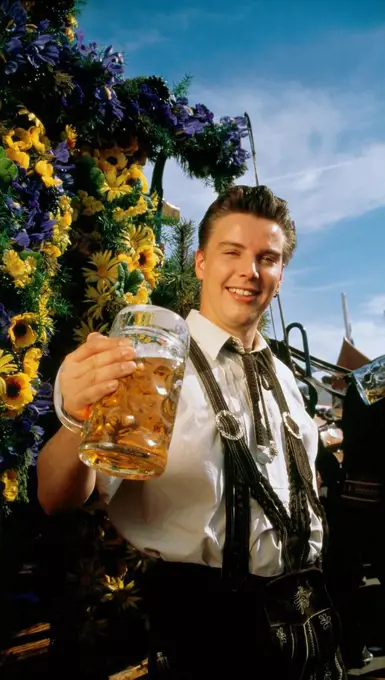 Man in Bavarian costume with a beer mug in his hand, Oktoberfest