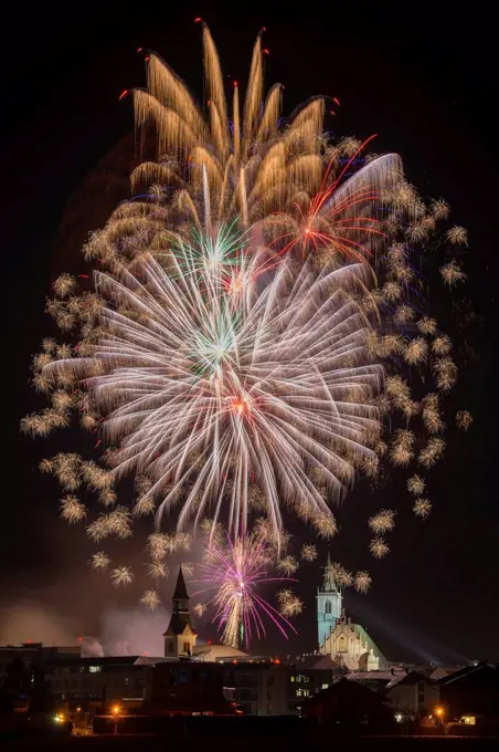 Fireworks over Schwaz on New Year's Eve with hospital church and parish church, Schwaz, Tyrol, Austria