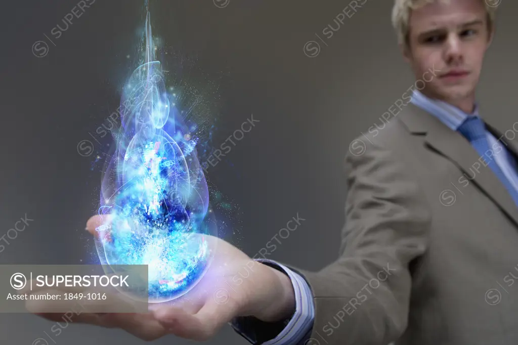Businessman holding glowing ball