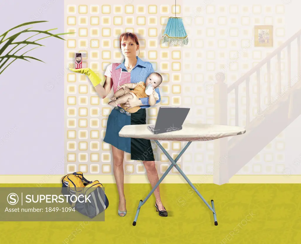 Mother with ironing board holding cell phone and baby