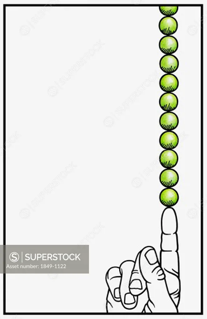 Stack of peas balanced on pointing finger