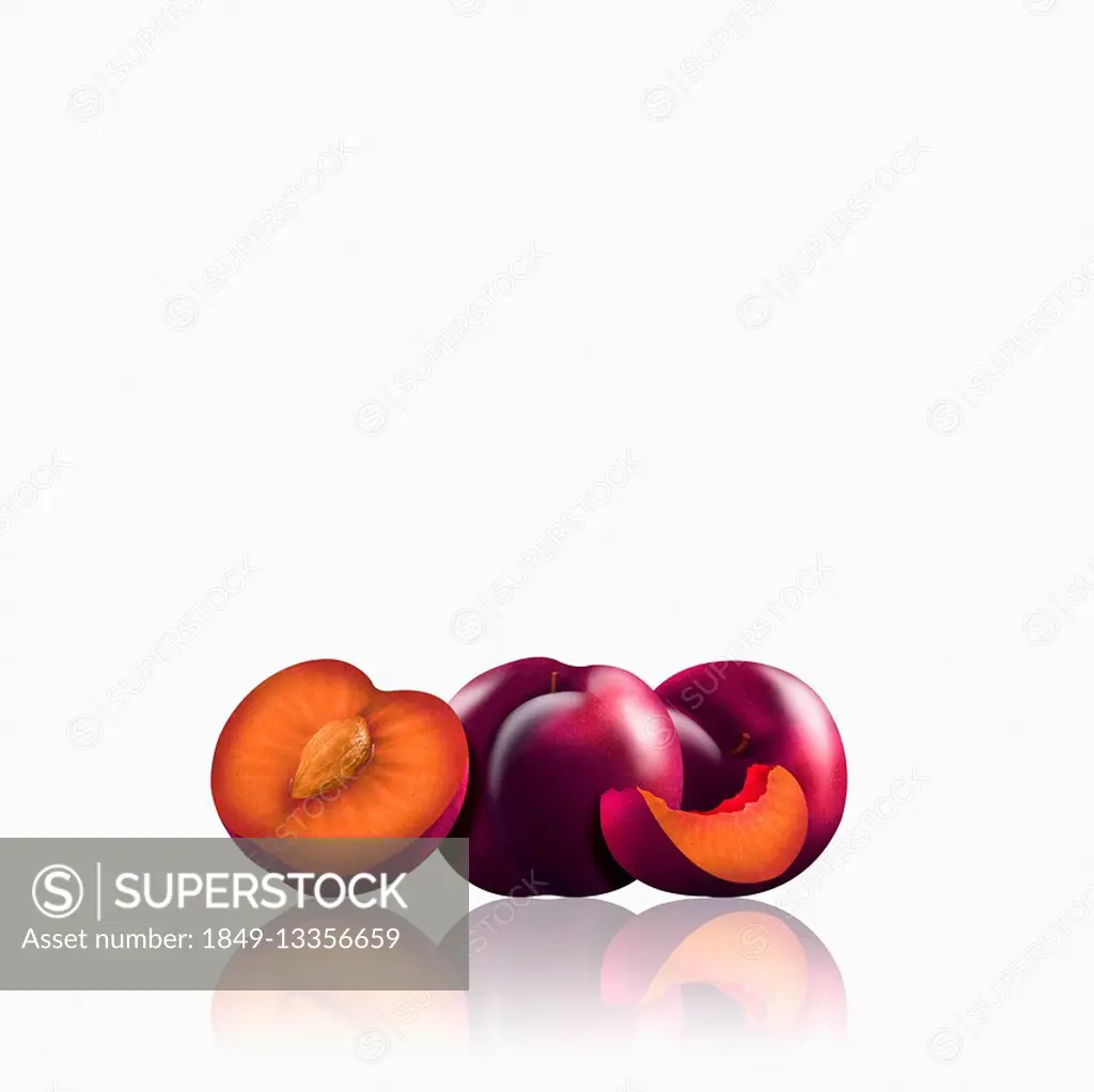 Whole and cut red plums