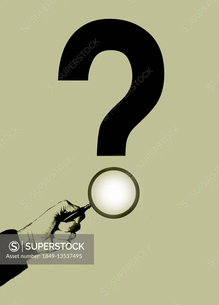 Hand holding magnifying glass over question mark