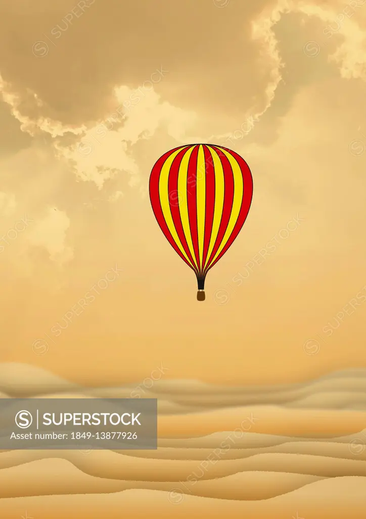 Hot air balloon flying over sand dunes