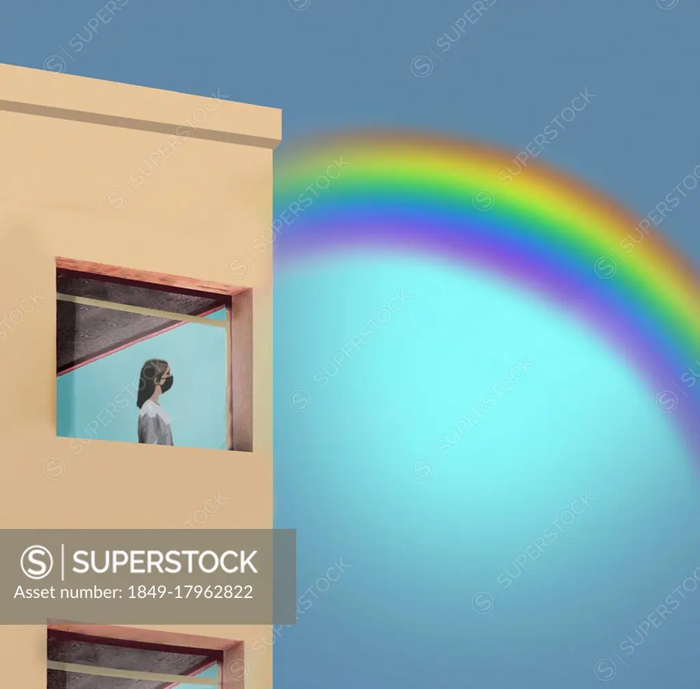 Woman in lockdown looking at rainbow through window