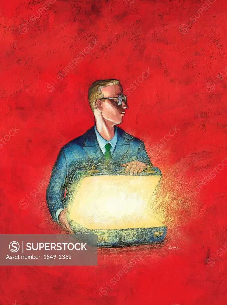 Businessman opening a glowing suitcase