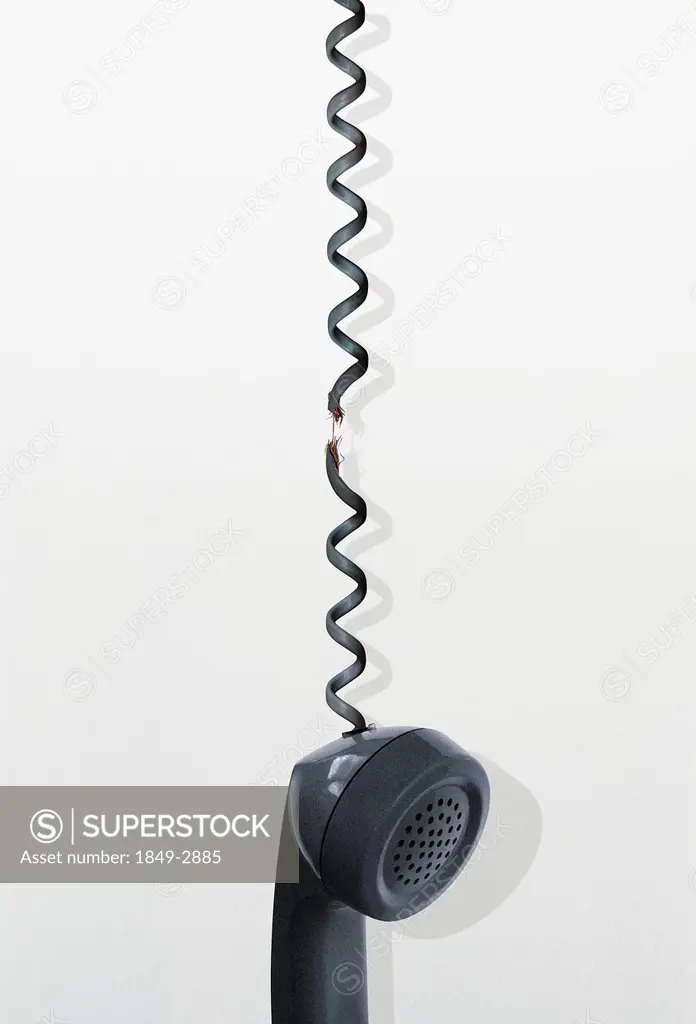 Telephone handset dangling from frayed cord