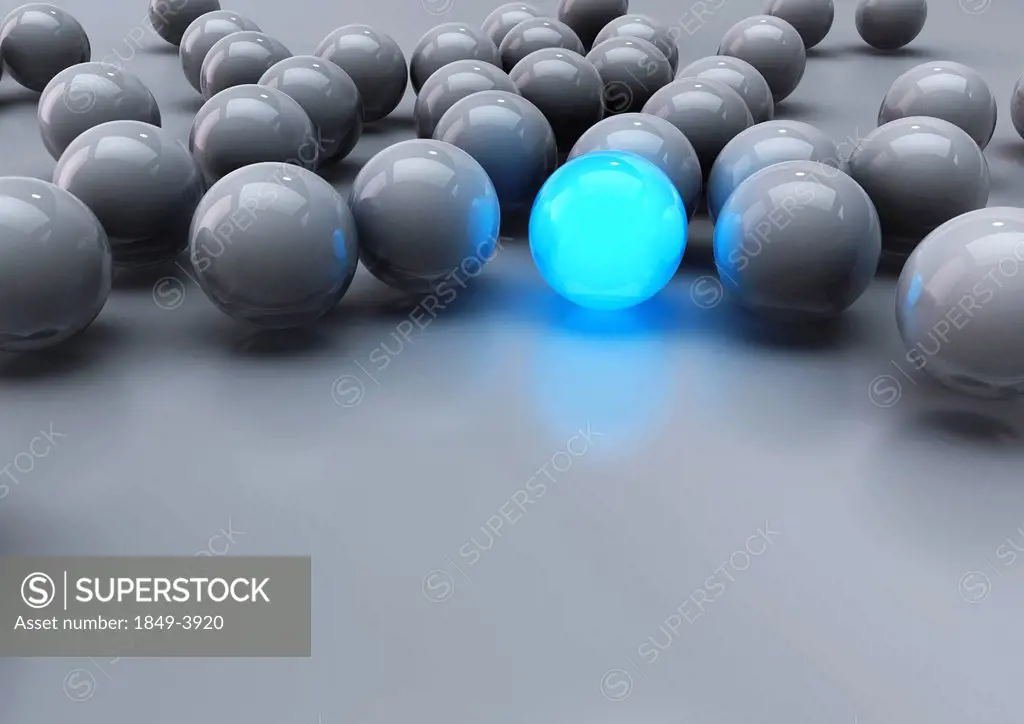 Glowing blue ball among grey balls