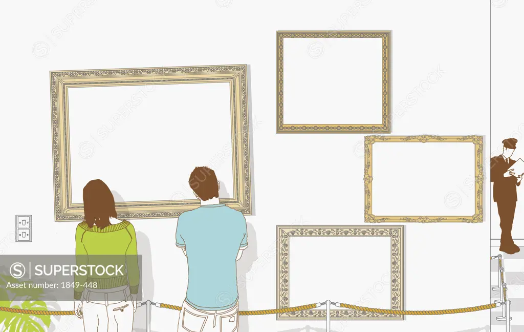 Couple looking at empty frames in gallery
