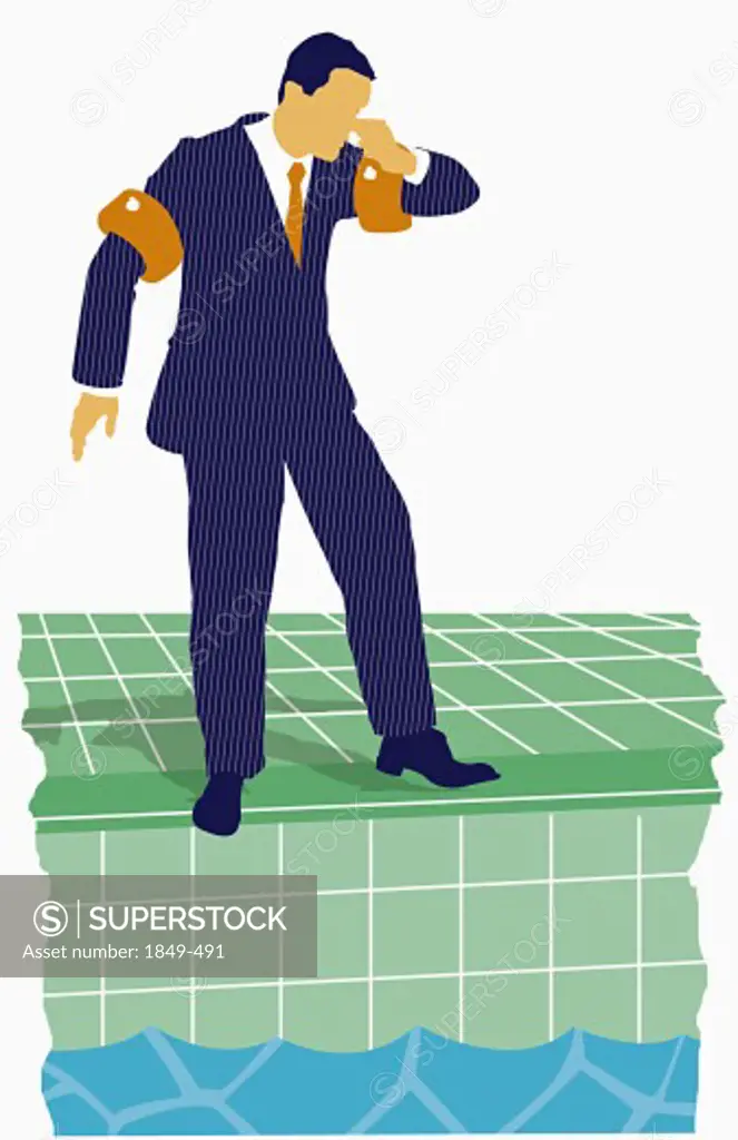 Businessman standing by swimming pool