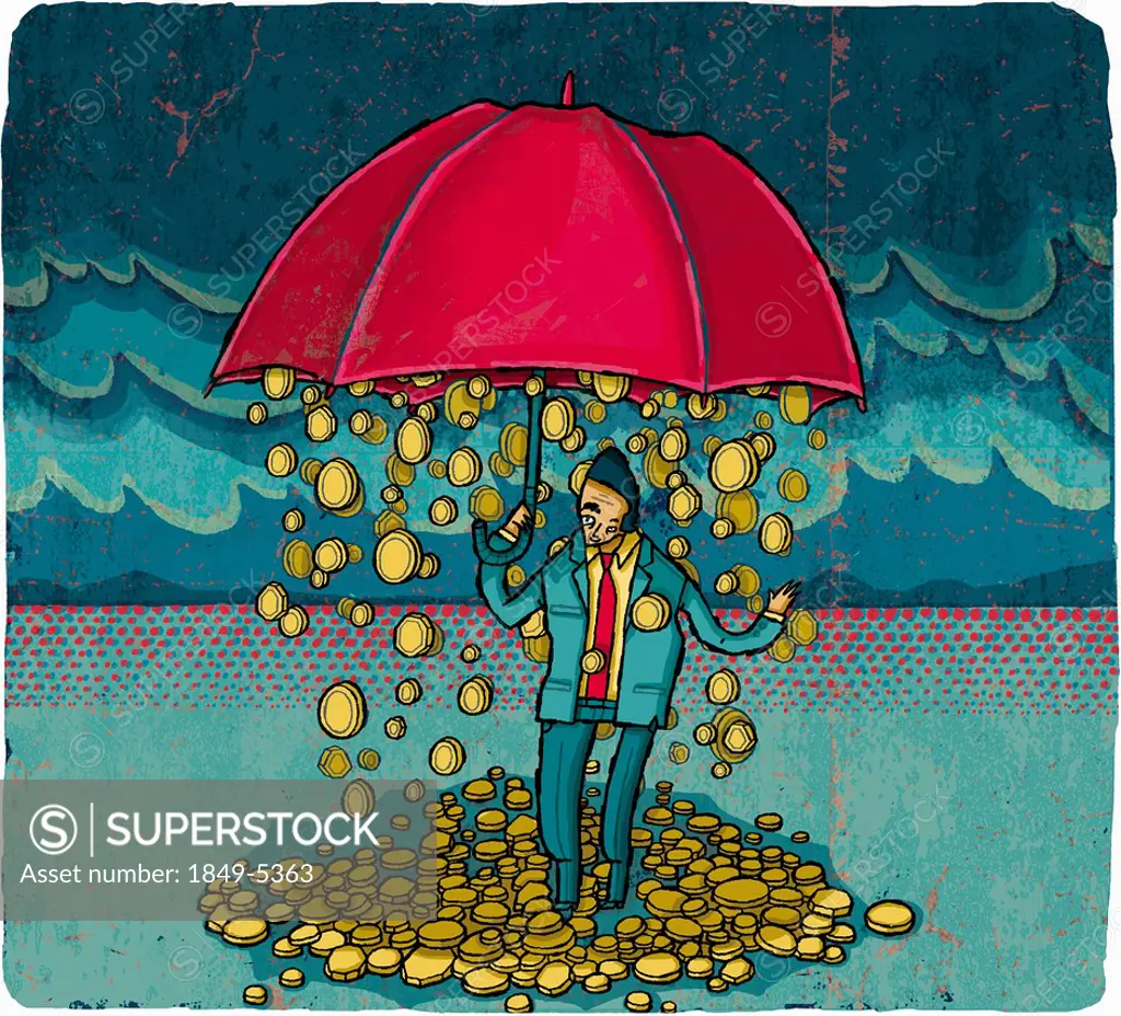 Coins falling from umbrella over businessman