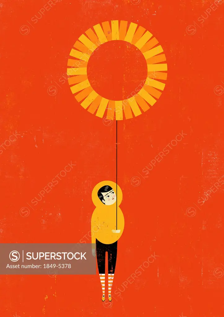 Boy holding sun balloon