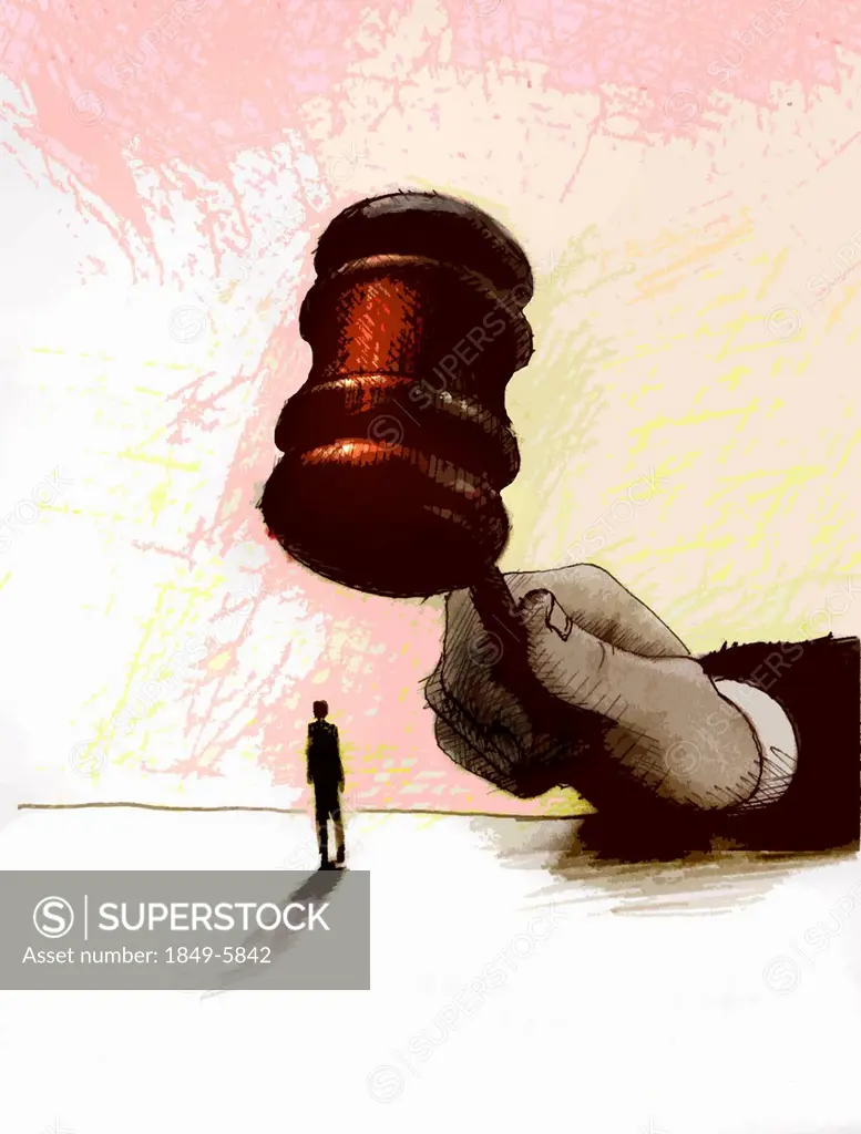 Large hand with gavel over businessman