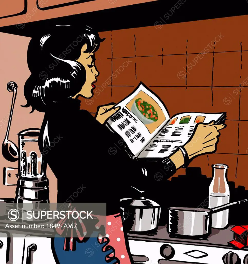 Woman reading cookbook in kitchen