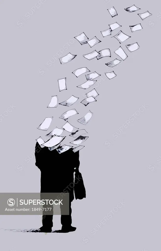 Businessman breaking up into sheets of paper