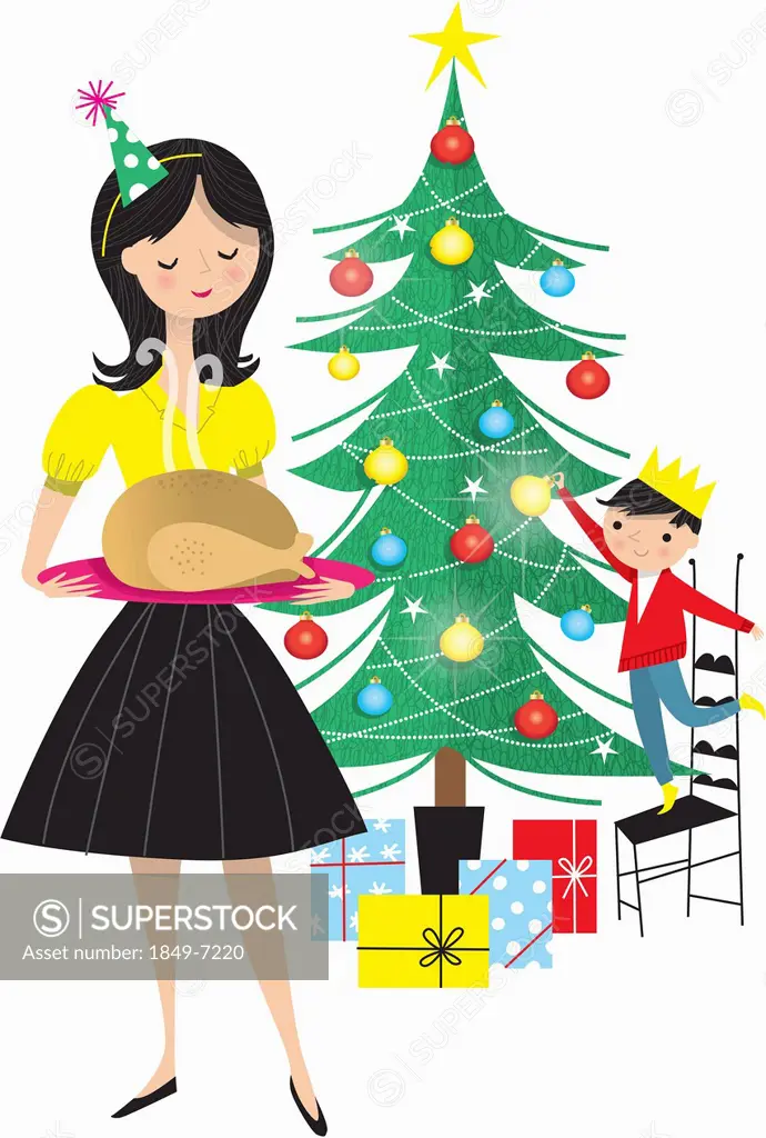 Mother holding turkey on tray with boy decorating Christmas tree