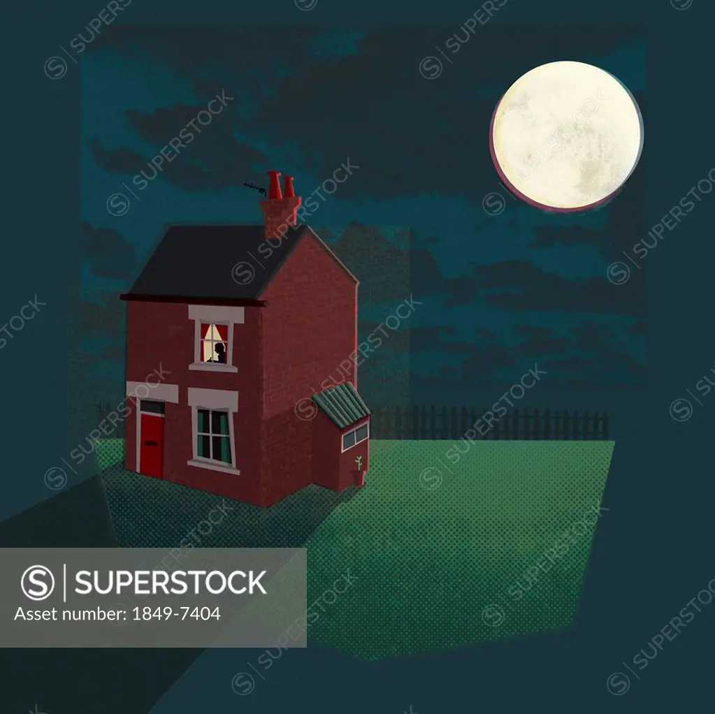 Man working late illuminated in window of house at night with bright full moon