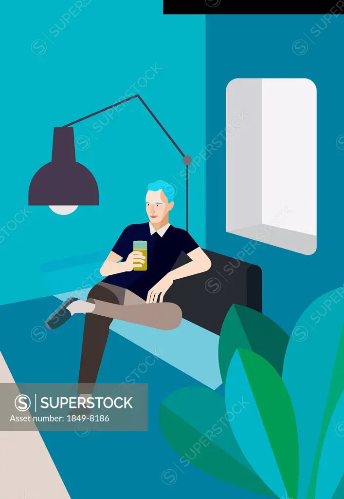 Man relaxing on sofa with drink