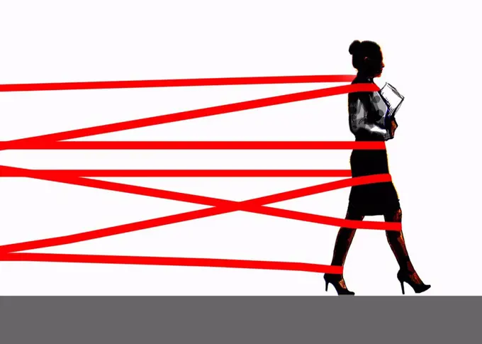 Businesswoman being held back by red tape