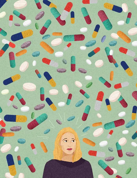 Anxious woman surrounded by lots of pills