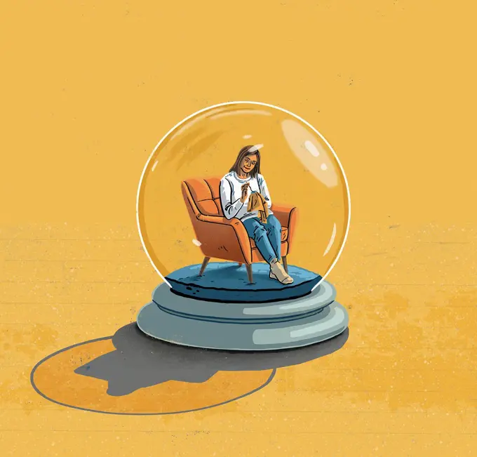 Woman sitting at home inside snow globe